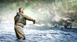 Fisherman hunting fish trouts in mountain river.
