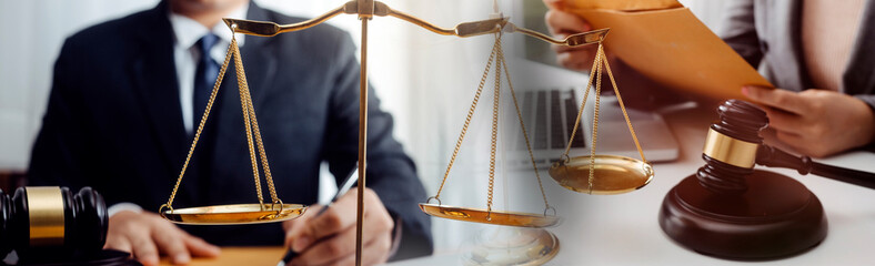 Business and lawyers discussing contract papers with brass scale on desk in office. Law, legal services, advice, justice and law concept picture with film grain effect