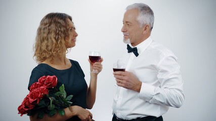 Wall Mural - An elderly couple raises their glasses of wine at a celebration. Happy elderly