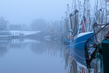 Fishing Boats In The Wintry Harbor Of Greetsiel
