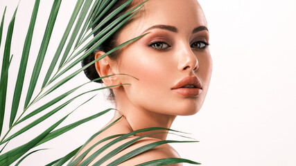 young beautiful woman with green leaves near naked body. body care beauty treatments concept. girl's