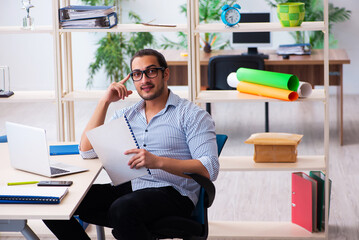 Young male employee working in the office