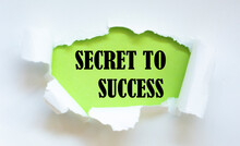 The Text SECRET TO SUCCESS Appearing Behind Torn White Paper