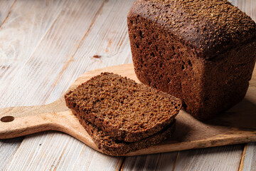 Closeup on sliced rye bread on the wooden cutting board