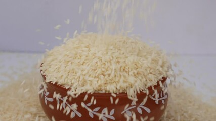 Sticker - Micro shot of dropping rice over a mud bowl filled with rice