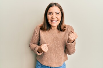 Sticker - Young beautiful woman wearing casual clothes celebrating surprised and amazed for success with arms raised and eyes closed