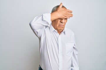 Sticker - Handsome senior man wearing casual white shirt covering eyes with hand, looking serious and sad. sightless, hiding and rejection concept