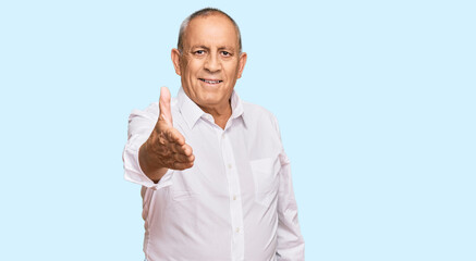 Poster - Handsome senior man wearing elegant white shirt smiling friendly offering handshake as greeting and welcoming. successful business.