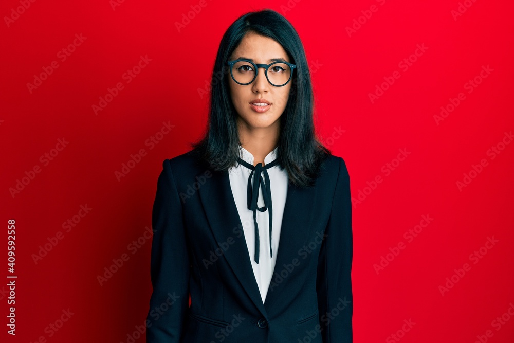 Beautiful asian young woman wearing business suit relaxed with serious expression on face. simple and natural looking at the camera.