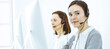 © Iryna - Call center. Casual dressed woman working in headset with diverse colleagues at office. Business concept