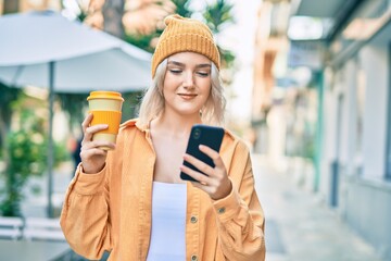 Sticker - Young blonde girl using smartphone and drinking coffee at the city.