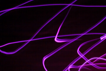 Wall Mural - long exposure pink lights abstract texture background. pink lights drawing patterns on black backgro