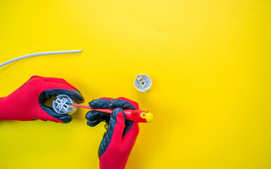 Wall Mural - Electrician peeling off insulation from wires - closeup on hands and pliers