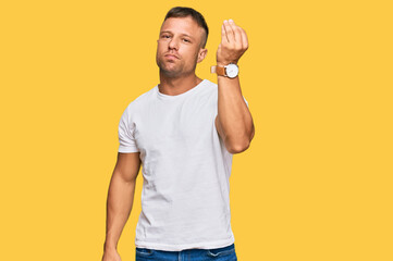 Sticker - Handsome muscle man wearing casual white tshirt doing italian gesture with hand and fingers confident expression