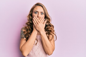 Wall Mural - Young blonde girl wearing casual clothes shocked covering mouth with hands for mistake. secret concept.