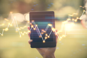 Double exposure of forex chart sketch hologram and woman holding and using a mobile device. Financial market concept.