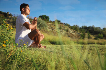 Wall Mural - Man meditating outdoors, space for text. Nature healing power