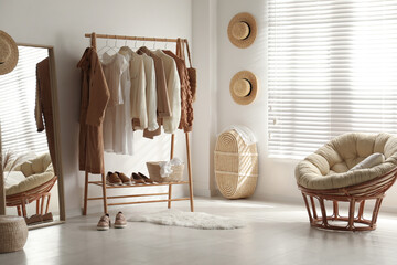 modern dressing room interior with rack of stylish women's clothes
