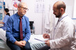 © DC Studio - Surgeon wearing stethoscope discussing treatment in examination room with senior man. Elderly patient having a converstation with medical stuff in private clinic during consultation.