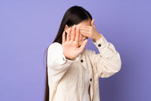 Young Asian Woman Isolated On Purple Background Making Stop Gesture And Covering Face