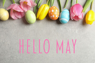 Wall Mural - Hello May. Flat lay composition of painted Easter eggs and spring flowers on grey background