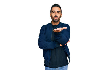 Poster - Young hispanic man wearing casual clothes looking at the camera blowing a kiss with hand on air being lovely and sexy. love expression.