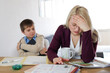 © Victoria - Mother is tired of homeschooling. Boy and woman are arguing at home. Homeoffice with kids