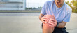 © anut21ng Stock - asian man hold on his knee pain with copy space for text, Injury from workout concept