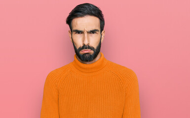 Wall Mural - Young hispanic man wearing casual clothes depressed and worry for distress, crying angry and afraid. sad expression.