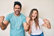 © Krakenimages.com - Beautiful young couple of boyfriend and girlfriend together angry and mad raising fists frustrated and furious while shouting with anger. rage and aggressive concept.