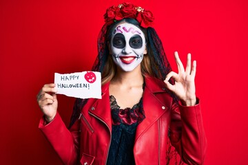 Sticker - Woman wearing day of the dead costume holding happy halloween paper doing ok sign with fingers, smiling friendly gesturing excellent symbol