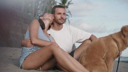 side view medium long of dark-haired beautiful caucasian girl hugging and kissing her young boyfrien