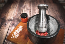 Kitchen Mortar With Red Berries On A Wooden Board