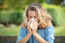 Woman With With Allergy Symptom Blowing Nose