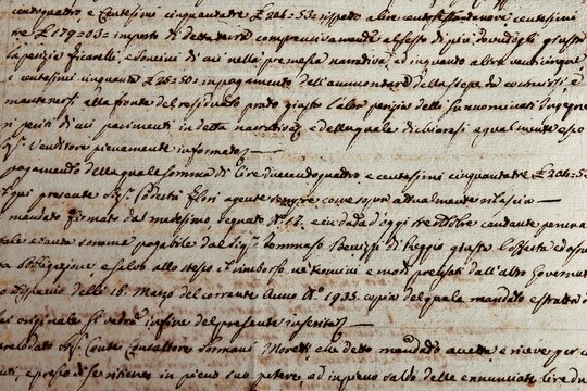 Ancient manuscript of 1700 century written in ink and goose pen in Italian. Antique letter with handwritten text. Stained texture background. Vintage style toned picture 