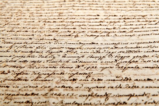 Ancient manuscript of 1700 century written in ink and goose pen in Italian. Antique letter with handwritten text. Stained texture background. Vintage style toned picture 