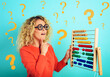 © alphaspirit - Girl with abacus is confused about the sum . cyan background