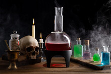 Magic Potions, Skull And Candles On Table. Health And Mana Potion. Various Kind Of Flasks  Magic And Wizard Concept.