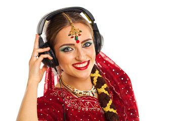 Beautiful Indian woman listening to music on headphones