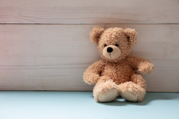 Wall Mural - Teddy bear sitting on blue floor, child room