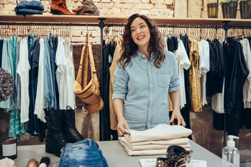 Canvas Print - Happy young woman working in a fashion store