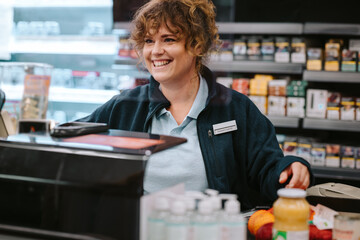 Wall Mural - Cashier working at supermarket checkout