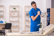 © Elnur - Young male doctor and skeleton patient in the clinic
