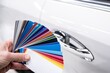 © Daniel Jędzura - Man choosing color of his car with color sampler. Car foil wrapping colors picker