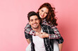© Look! - Appealing girl posing with boyfriend on pink background. Studio shot of smiling couple looking at camera.