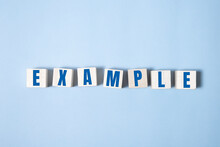 EXAMPLES Word Made With Building Blocks On Blue Background
