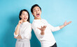 © Timeimage - Portrait of young couple standing posing on blue background
