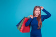 © Have a nice day  - Portrait Asian woman shopping online ecommerce advertisement banner blue isolated background copy space, summer sales holiday promotion, wearing sunglass holing shopping bags happy smiling excited