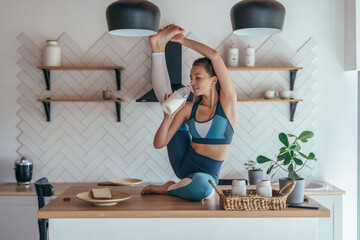 Wall Mural - Fit woman is warming up and eating at the same time.