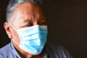 Old native american man wearing mask.